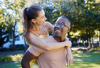 Image showing Interracial couple, care and piggy back of people with support, love and smile in a summer park. Freedom, hug and young man and woman outdoor on date together happy about bonding and dating in nature