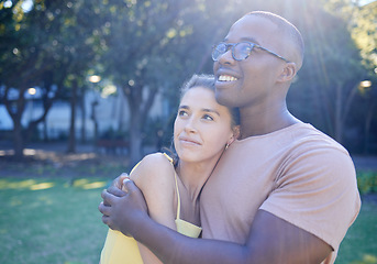 Image showing Interracial couple, hug and park with smile, thinking or love for bonding, together and vision of future. Multicultural relationship, black man and woman for happiness, outdoor and diversity on grass