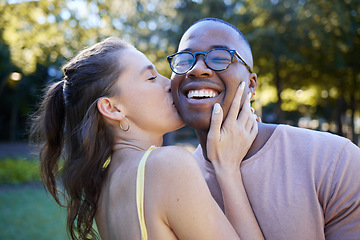 Image showing Woman kiss man, happiness and date in park, outdoor in nature with love and commitment in interracial relationship. Trust, support and happy couple, content with smile on face and fresh air