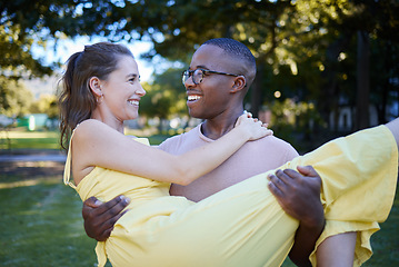 Image showing Love, park and carrying with an interracial couple bonding outdoor together on a romantic date in nature. Summer, romance and diversity with a man and woman dating outside in a green garden