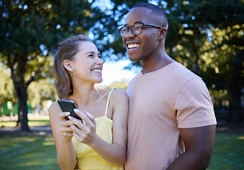 Image showing Comedy, laughing and interracial couple with a phone in nature, funny communication and smile at a meme. Comic, streaming and black man and woman reading a joke on a mobile in a park in France