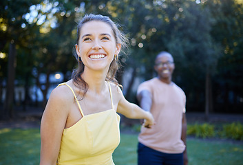 Image showing Interracial, couple holding hands and park with happiness, romance and bonding outdoor, love or relationship. Romantic, woman and black man in nature, joyful or touching hand on date and quality time