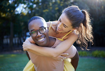 Image showing Piggyback, smile and portrait of couple at park in interracial love, nature wellness and support walking in summer. Trees, freedom and happy black man with woman or people having fun together on date