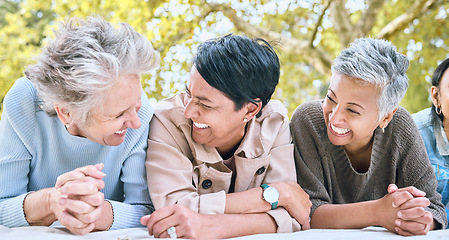 Image showing Retirement, women and friends laugh at park together for bonding, wellness and relaxing lifestyle. Happiness, funny and smile of senior people in interracial friendship on blanket in nature.