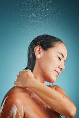 Image showing Water splash, cleaning and shower of a young model woman holding her back to clean with soap. Bathroom hygiene, wellness and beauty of a person morning routine for healthy skin and skincare