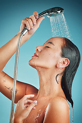 Image showing Cleaning, water and shower, woman with hygiene and body care, washing and beauty against blue studio background. Skin hydration, skincare and wellness with Asian model for grooming and clean.