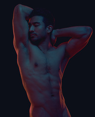 Image showing Erotic, nude and body of a sexy Asian man in dark light isolated on a black background. Seductive, art and strong naked Japanese model flexing for sensuality, desire and creativity on a backdrop