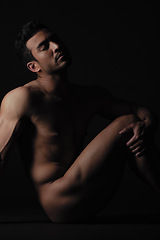 Image showing Nude, art and freedom with a model asian man in studio on a dark background for artistic body positivity. Skin, natural and artwork with a handsome young male posing naked on a black backdrop