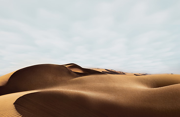 Image showing Sand, dessert and nature background in summer looking sexy like the beauty and body of a nude woman lying naked. Blue sky copy space above dry, arid and sandy terrain in the outdoor environment