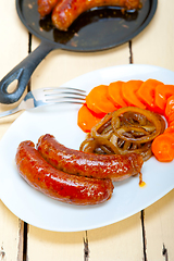 Image showing beef sausages cooked on iron skillet