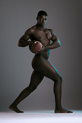 Image showing Portrait, nude and body with a model black man holding a football in studio on a gray background for health or sports. Art, muscle and fitness with a handsome young male posing naked for sport