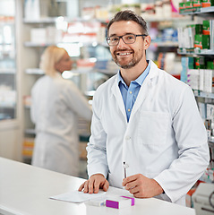 Image showing Portrait, service and pharmacist man at counter for medicine help, expert advice and healthcare pharmacy. Retail desk, store and medical professional worker, doctor or person with a friendly smile