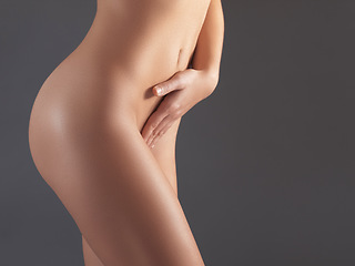 Image showing Naked, woman and cosmetics for body, dermatology and natural beauty on grey studio background. Female with nudity, lady and nude with confidence, wellness and stomach with smooth and clear skin