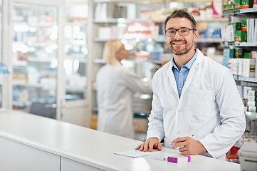 Image showing Portrait of happy pharmacist man with pharmacy services, medicine advice and product trust at shop, retail counter. Inventory, stock help desk and medical professional worker, person or doctor smile