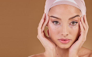 Image showing Woman, muslim and studio portrait for beauty, makeup and wellness with hands on face by background. Islamic model, natural skin glow and hijab with cosmetic health, soft aesthetic or healthy skincare