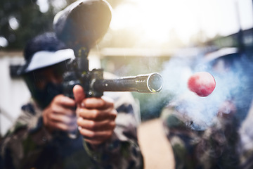 Image showing Paintball, gun and ball closeup with person shooting for fun, extreme and sport, fitness and training. Zoom, paintball marker, and target, practice and game with people competing, speed and power