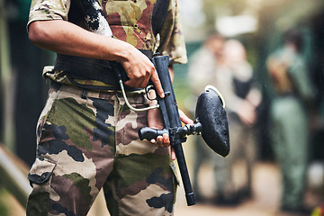 Image showing Soldier, paintball gun and ready for war, game or military fight in extreme sports in the outdoor arena. Sporty army player in holding fire in preparation for match start, begin or commence at field