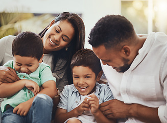 Image showing Love, happy and parents tickling their children in the outdoor backyard of their family home. Happiness, smile and young couple spending quality time, bonding and fun with their kids in house garden.