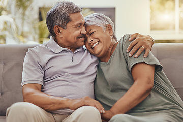 Image showing Happy, love and senior couple on a sofa hugging, bonding and relaxing together in their living room. Happiness, laugh and elderly man and woman pensioners in retirement embracing on a couch at home.