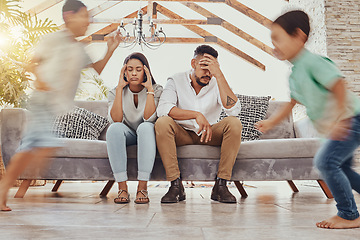 Image showing Tired parents, kids running and family in a living room feeling anxiety, headache and stress. Children chaos, run and fatigue of mom and father together on a couch frustrated from parent care