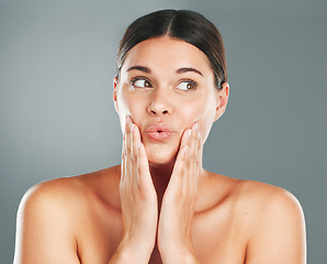 Image showing Skincare, beauty and shocked woman in a studio for a health, wellness and natural face routine. Cosmetic, surprise and female model with a healthy facial treatment isolated by a gray background.