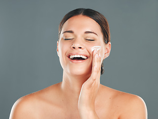 Image showing Skincare, beauty cream and woman with happiness from sunscreen and self care in studio. Wellness, spa and smile of a model laugh with collagen lotion with studio background and dermatology treatment