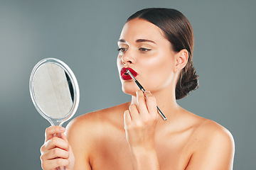 Image showing Lipstick, mirror and woman face getting ready with cosmetics and makeup brush. Mouth, female and beauty model looking at reflection with cosmetic tool with isolated studio background and lips product