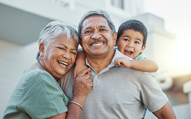 Image showing Grandparents, hug and child with smile for happy holiday or weekend break with elderly people at the house. Portrait of grandma and grandpa holding little boy on back for fun playful summer together