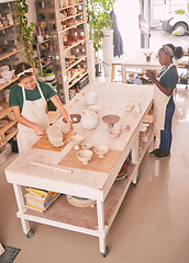 Image showing Pottery business and workshop people sculpting together for creative process and productivity with tools top view. Focus, concentration and skill of interracial artist team in workspace.