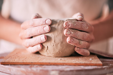 Image showing Creative, pottery and design with hands of woman in workshop studio for mold, ceramics and art. Clay, sculpture and manufacturing with girl artisan on table for crafting, handmade and hobby