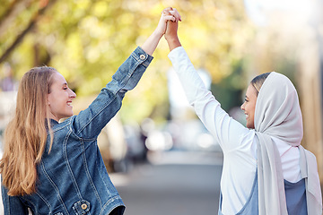 Image showing Woman, friends and holding hands walking in the street with smile for holiday weekend or friendship in the outdoors. Happy women taking a walk together smiling in happiness for adventure in nature