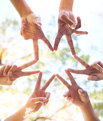 Image showing Hands together, star sign and team sun gesture with hand to show group work and community. Outdoor, lens flare and below of people doing teamwork with friends showing commitment and solidarity