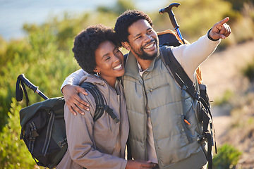 Image showing Black couple, happy and pointing on hike adventure for outdoor exploration, sightseeing and journey. Happiness, love and care of people trekking with backpack together with excited smile for travel.