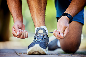 Image showing Fitness, running and man tie shoes for exercise, marathon training and cardio workout in outdoor park. Sports, performance and zoom of runner with sneakers lace for wellness, healthy body and jog