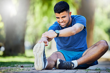 Image showing Exercise, man on ground and stretching legs, workout and training for fitness, warm up and wellness outdoor. Relax, male athlete and runner stretch, sports and performance for endurance and energy