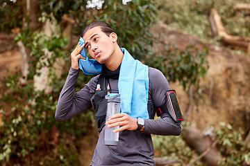 Image showing Fitness, sweat and man running on a mountain for exercise or training for a race or marathon. Sports, health and young male athlete or runner taking a break while doing a cardio workout in nature.