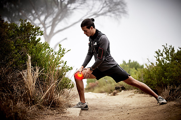 Image showing Exercise, knee pain and man stretching, nature and workout for wellness, health and injury on trail. Male, athlete or runner with sports accident, leg or training with torn muscle, strain and outdoor