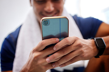 Image showing Phone, fitness and social media with a sports man typing a status update to post his workout progress. Mobile, exercise and app with a male athlete tracking his workout while training in a gym