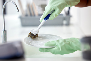 Image showing Cleaning, kitchen and soap water with hands of woman cleaner to clean plate with a brush for hygiene. Maid service for washing dishes to wash away bacteria, dirt or virus in house, home or apartment