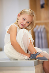 Image showing Portrait, children and shoes with a girl customer shopping in a mall or retail store for footwear. Fashion, kids and clothes with a female child trying on a new shoe for trendy style as a shopper