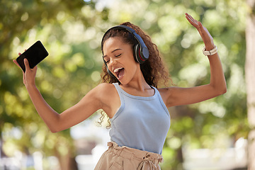 Image showing Phone, music and dance with a black woman listening to the radio in the park during summer while feeling free. Freedom, sing and dancing with an attractive young female streaing audio in a garden