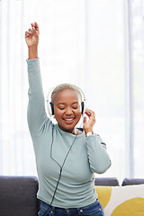 Image showing Music, dance and happy black woman listening to African radio, audio podcast or digital playlist song. Wellness girl, dancing energy and excited dancer hearing, enjoy and streaming sound at home