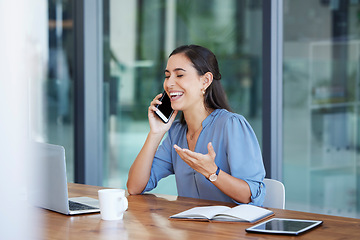 Image showing Phone call, communication and laugh with a business woman talking while sitting in her office for work. Laptop, mobile or internet with a female employee working at her desk and laughing at a joke