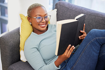 Image showing Black woman, relax smile and reading book on sofa in living room for calm peace, happiness and studying in home. Young african girl, happy student and relaxing with notebook or university textbook