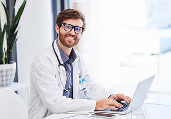 Image showing Doctor, research and healthcare portrait with online service, telehealth advice and mission for hospital management. Clinic or medical professional man or person typing on laptop for virtual support