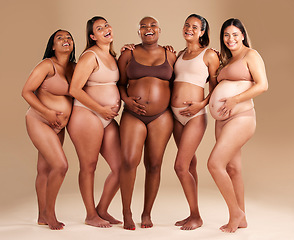 Image showing Pregnancy, body and portrait of happy friends in a studio for diversity, motherhood and prenatal wellness. Maternity, beauty and pregnant women showing baby bump stomach together by beige background.