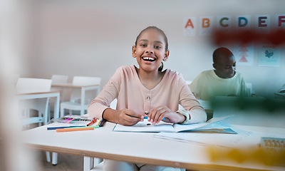 Image showing Education, learning and portrait of child with smile in classroom for reading, writing and math in Montessori school. Books, students and happy girl at desk with fun notebook studying for future exam