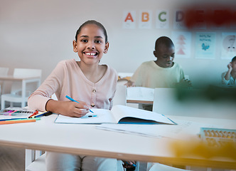 Image showing Education, class and portrait of child with smile in classroom learning reading, writing and math in Montessori school. Books, students and happy girl at desk with notebook studying for future exam.