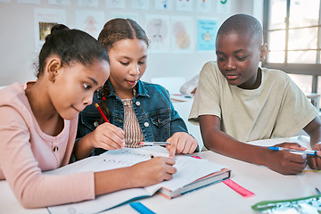 Image showing Teamwork, education and children with class project, working together in Montessori school at desk. Books, help and diversity, young students writing or drawing in notebook for math test or homework.