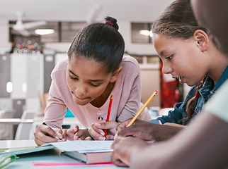 Image showing Kids, students and group writing in classroom for learning activity and education together with stationery. Young children working on literacy and academic exercises for development at school desk.